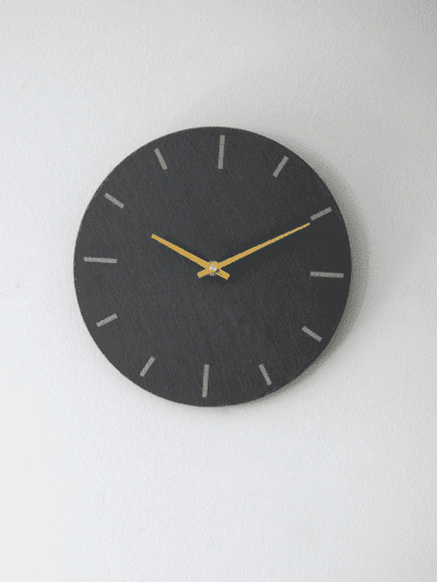 Garden Trading Wall Clock hanging on a white wall