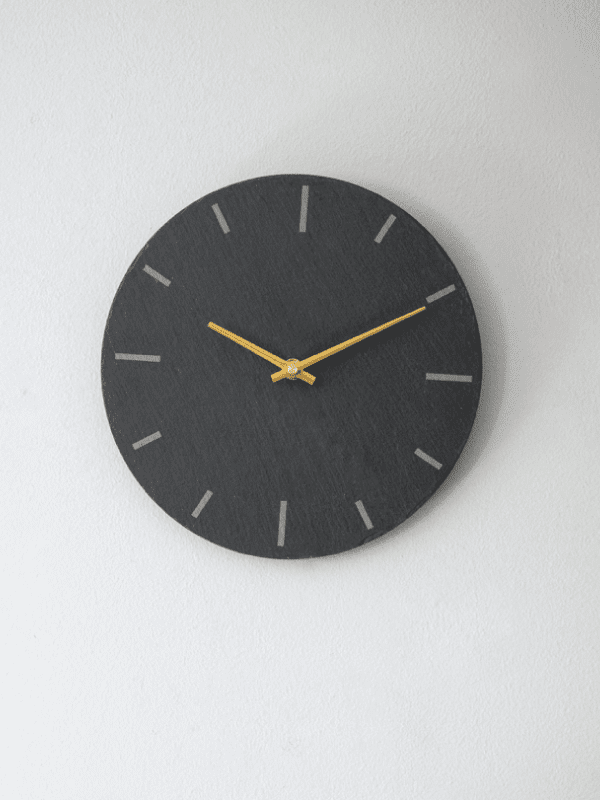 Garden Trading Wall Clock hanging on a white wall