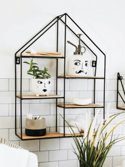 black shelf unit in a house shape, in bathroom