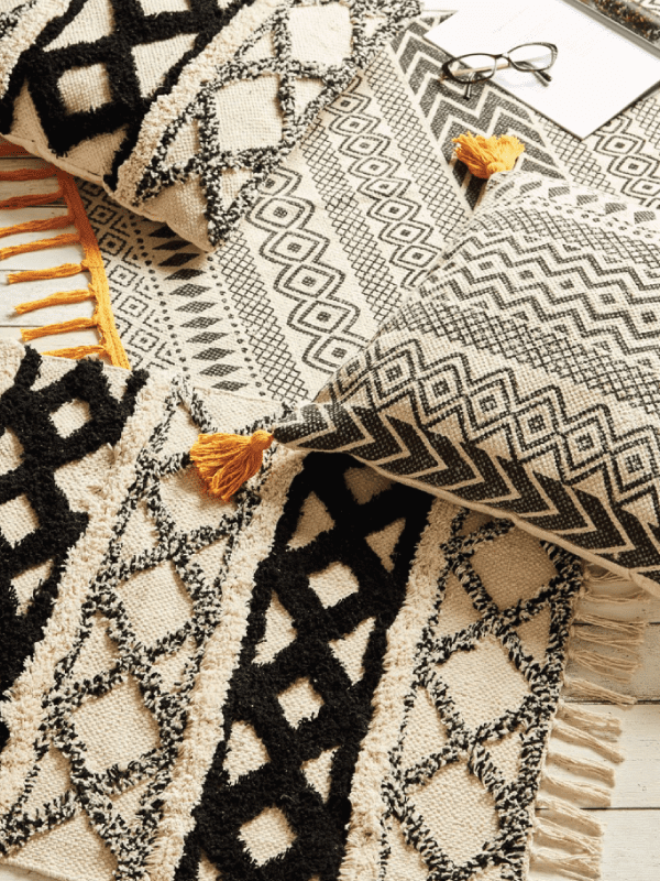 Scandi geometric prints on pillows and rug in a home