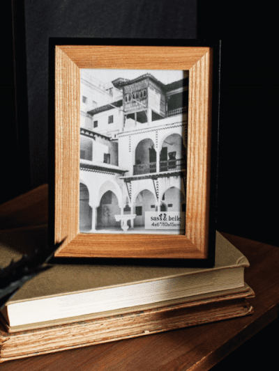 wood and black Frame standing on a coffee table