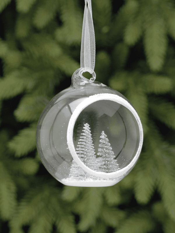 festive open glass bauble with trees inside