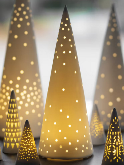 Räder porcelain LED light tree in white matte finish, elegant openwork Christmas decoration glowing softly with warm white light.