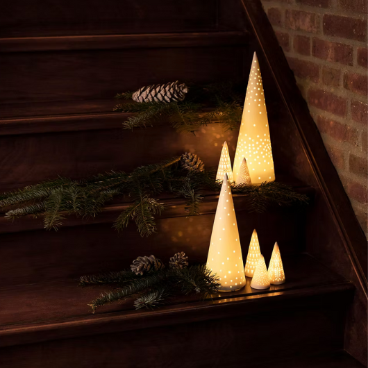LED Mini Light Fir Tree Medium by Räder Design – white porcelain with cut-out pattern glowing softly