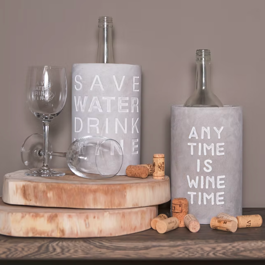 Concrete wine cooler by Räder Design embossed with “Anytime Is Wine Time,” perfect for wine lovers and stylish home décor.