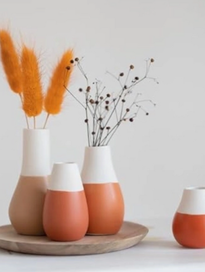 Set of four handcrafted porcelain mini vases by Räder Design in warm earthtones with glazed and unglazed finish, perfect for small flowers.