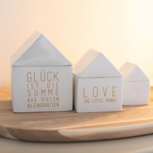 White porcelain house-shaped treasure box with gold “Love the little things” lettering by Räder Design.