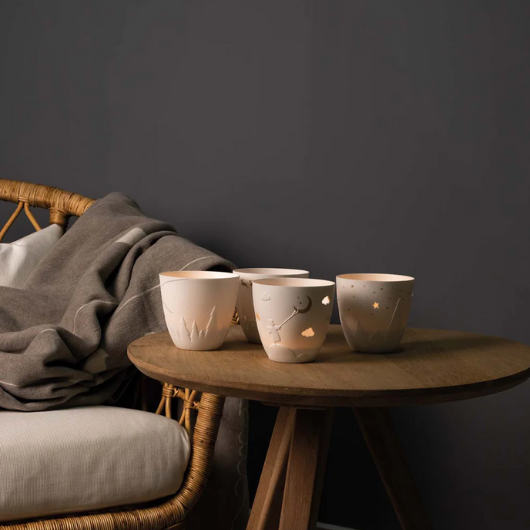 White and gold porcelain Räder Angel tealight holder, 9cm diameter × 9cm high, unglazed with decorative relief and printed design.