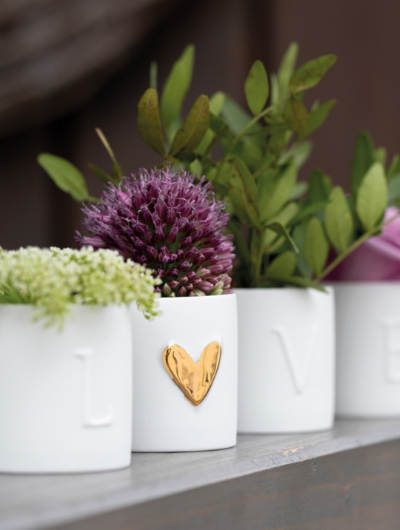 Set of 4 porcelain Räder Love Lights tealight holders spelling LOVE with a gold heart, handcrafted, elegant home décor.