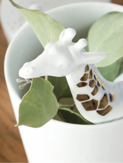 Rader White porcelain vase featuring a 3D giraffe with hand-painted gold markings, glazed inside and matte outside, perfect for flowers or display.