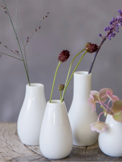 Set of four handcrafted white stoneware mini vases by Räder Design, glazed inside and half-glazed outside, perfect for small flowers.