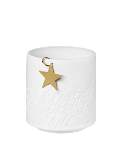 Small Räder porcelain Christmas tealight with "Christmas" cut out in multiple languages. Features a hanging gold metal star. Diameter 8 cm, height 8.5 cm.