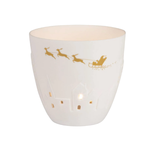 White and gold porcelain Räder Poetrylight tealight holder featuring Santa’s sleigh and reindeer with embossed houses.