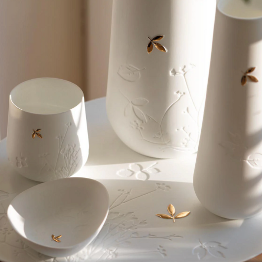 Porcelain Stories Leaf Tealight Holder with embossed twigs and gold leaf accent.