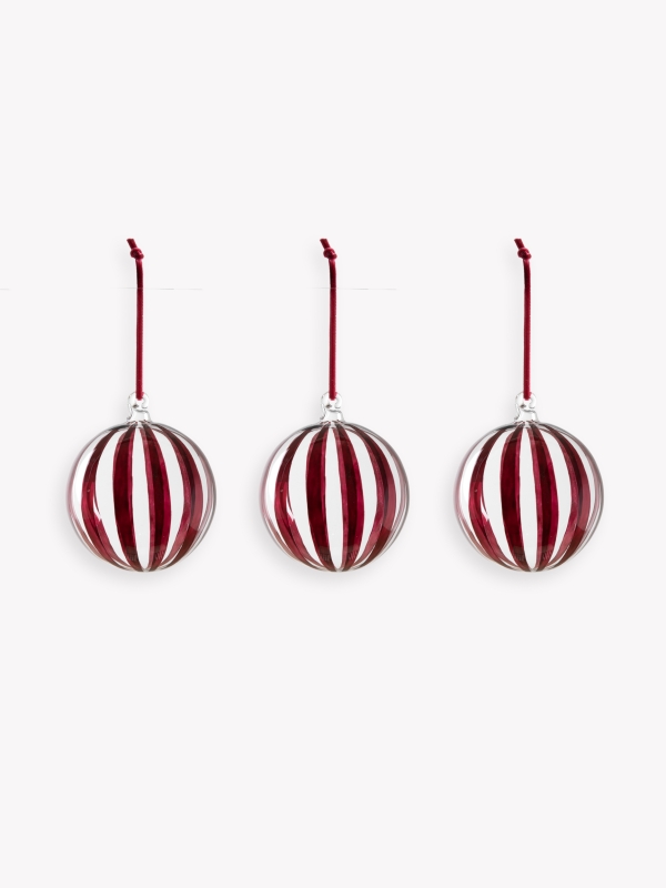 Set of three clear glass Purton Striped Christmas Baubles with hand-painted berry stripes and matching velvet ribbons, hanging on a Christmas tree.