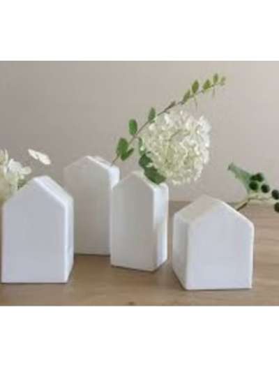 Set of four white porcelain miniature house bud vases by Räder Design.