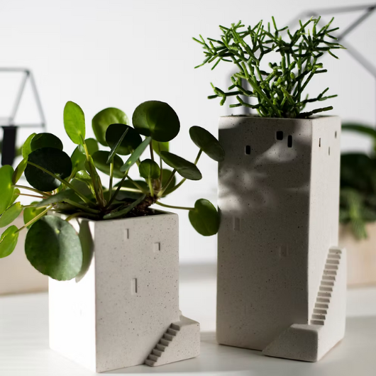 White mottled stoneware house planter by Räder with embossed details and cut-out windows, glazed inside for small plants.