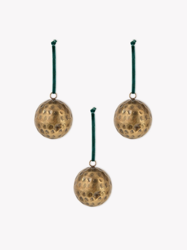 Set of three Ardington Hammered Baubles in antique brass with dark green velvet ribbons, perfect for a traditional red, green, and gold Christmas tree.