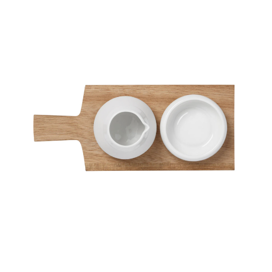 Oil and salt pots with acacia wood tray by Räder Designs, porcelain vessels by Indigo Ruh, versatile for oils, spices, or condiments.