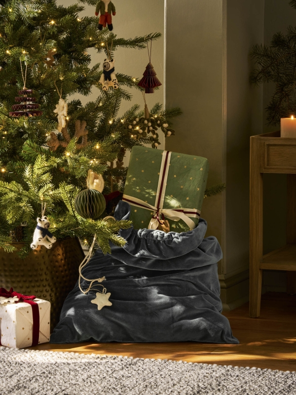 Hyde Christmas Sack in luxurious fern green cotton velvet. A large, elegant Christmas gift sack designed to hold presents too big for a stocking — perfect for hanging at the end of the bed on Christmas Eve.