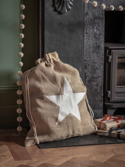 Festive jute Christmas sack with Snowflake or Star print and drawstring top, perfect for keeping presents hidden until Christmas morning.