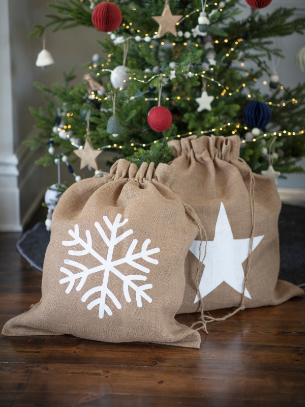 Festive jute Christmas sack with Snowflake or Star print and drawstring top, perfect for keeping presents hidden until Christmas morning.