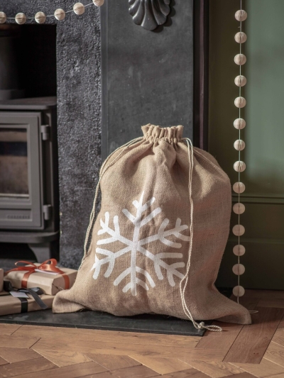 Festive jute Christmas sack with Snowflake or Star print and drawstring top, perfect for keeping presents hidden until Christmas morning.