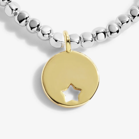 Radiance A Little One In A Million bracelet with gold star cutout charm on sentiment card.