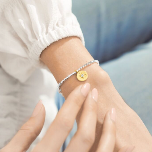 Joma Jewellery A Little You’re The Best bracelet with gold-plated charm on sentiment card.
