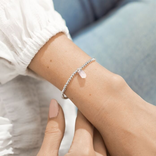 A Little Crystal Karma Howlite bracelet with silver beads and natural howlite charm on sentiment card.