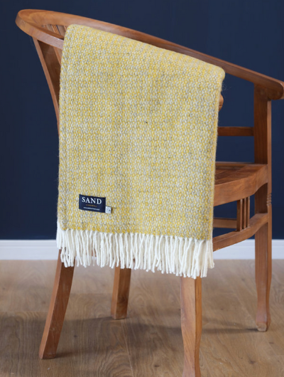 Illusion Yellow and Grey Wool Blanket Throw with cream tassels draped over sofa