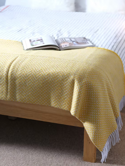 Yellow Diamond Wool Blanket Throw with twisted tassels draped on sofa
