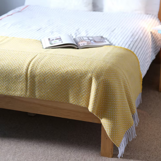 Yellow Diamond Wool Blanket Throw with twisted tassels draped on sofa