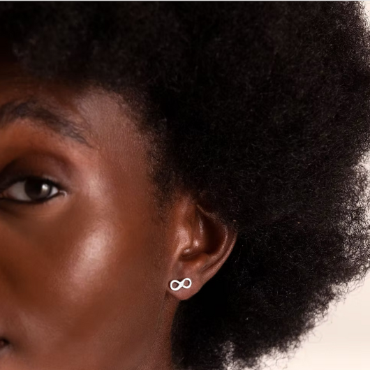 Model wearing Joma Jewellery Forever Friends infinity earrings, symbolising eternal friendship.