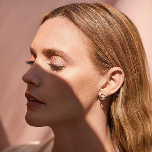 Model wearing Joma Jewellery November Birthstone yellow quartz stud earrings, symbolising happiness and positivity.