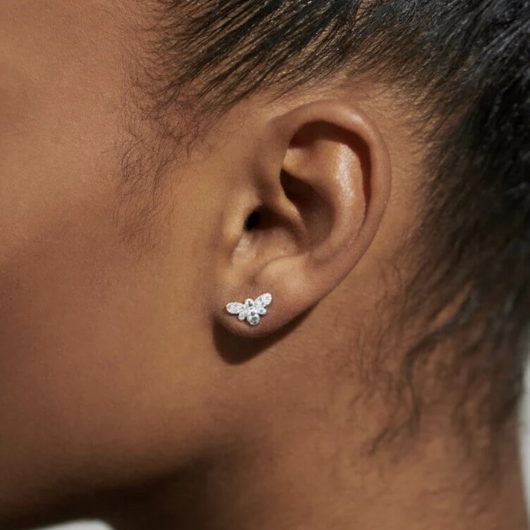 Model wearing Joma Jewellery Happy As Can Bee silver-plated bee stud earrings symbolising happiness and positivity.