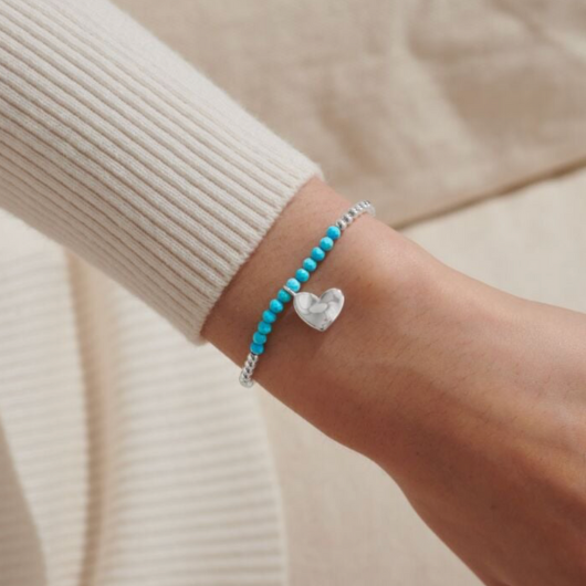 Joma Jewellery A Little December Birthstone bracelet with turquoise stones and silver heart charm on sentiment card.