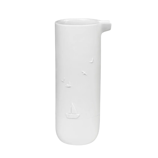 White porcelain watering jug by Räder with embossed lighthouse, boat, and bird design.