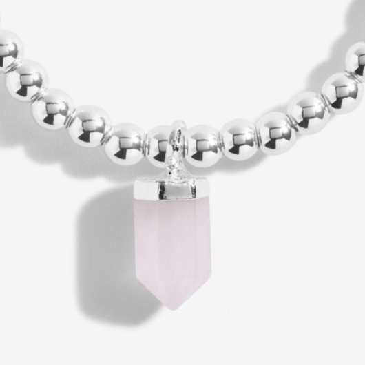 A Little Crystal Karma Howlite bracelet with silver beads and natural howlite charm on sentiment card.