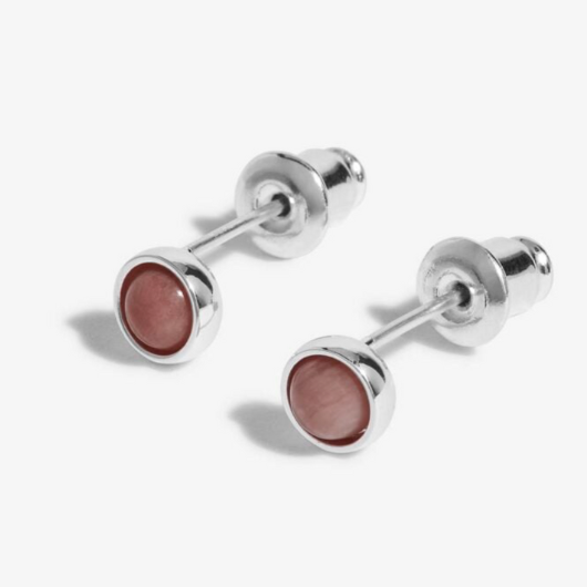 Close-up of Joma Jewellery October Birthstone Earrings with Tourmaline stones and traits card.