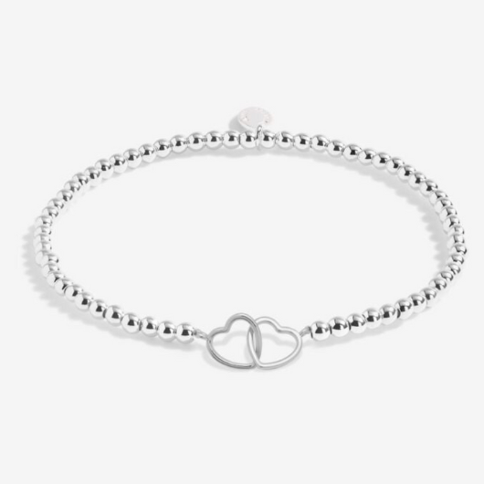 Joma Jewellery A Little Friendship silver-plated bracelet with interlinked double-heart charm on sentiment card.