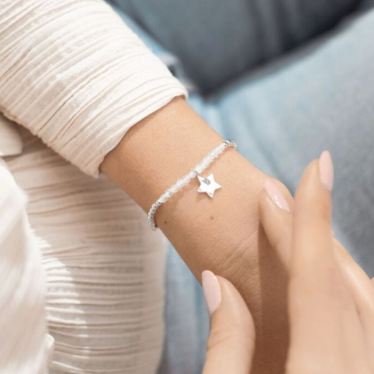 Joma Jewellery A Little April Birthstone bracelet with natural rock crystal stones and silver star charm on sentiment card.