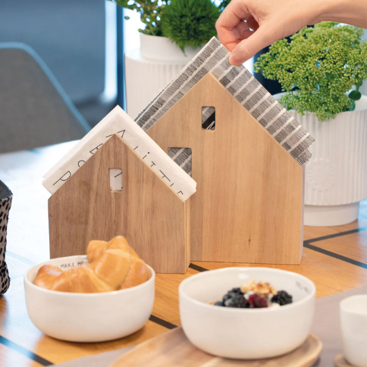 Village House Napkin Holder in acacia wood by Sarah Blienert, holding square dinner napkins.