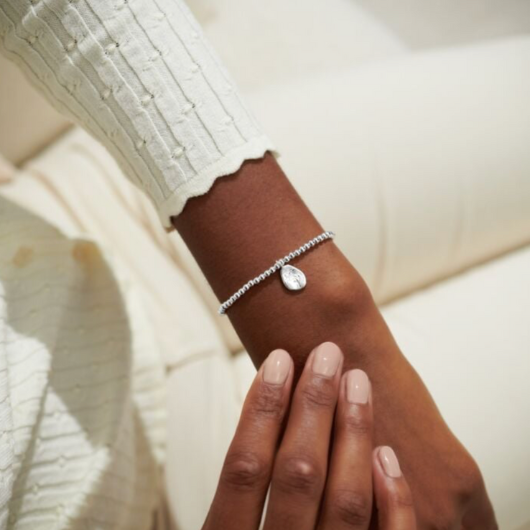 Joma Jewellery Birth Flower November Chrysanthemum silver-plated bracelet with engraved oval charm on pastel sentiment card.