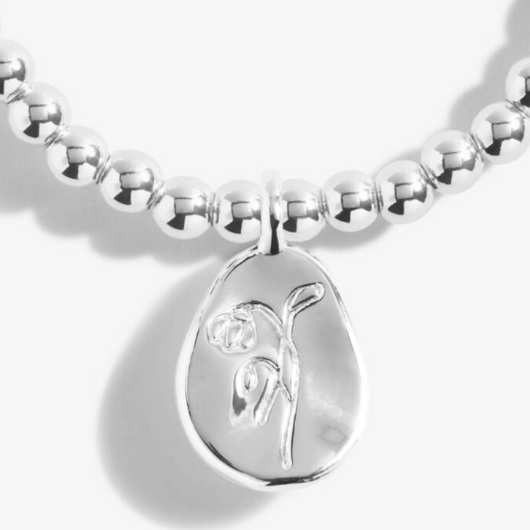 Joma Jewellery Birth Flower January Snowdrop silver-plated bracelet with engraved oval charm on pastel sentiment card.