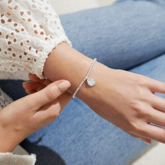Joma Jewellery Birth Flower February Violet silver-plated bracelet with engraved oval charm on pastel sentiment card.