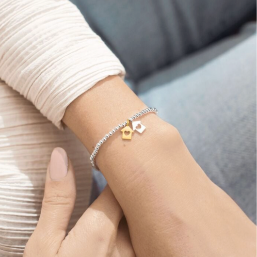Joma Jewellery A Little Neighbours By Chance silver and gold plated bracelet with house charms on sentiment card.