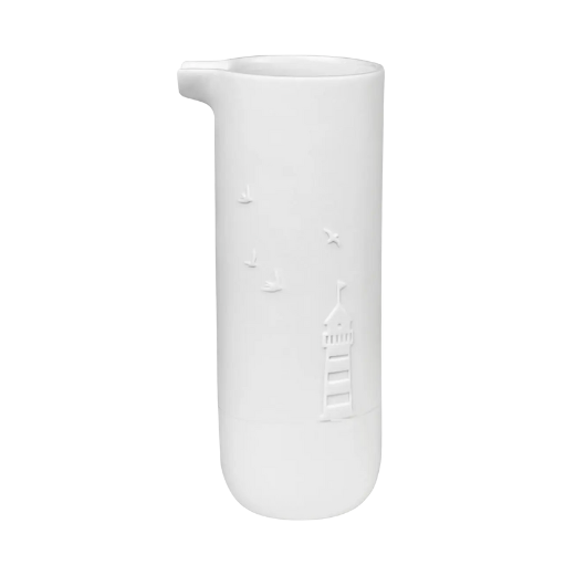 White porcelain watering jug by Räder with embossed lighthouse, boat, and bird design.