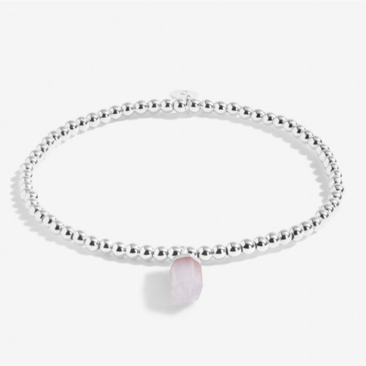 A Little Crystal Karma Howlite bracelet with silver beads and natural howlite charm on sentiment card.