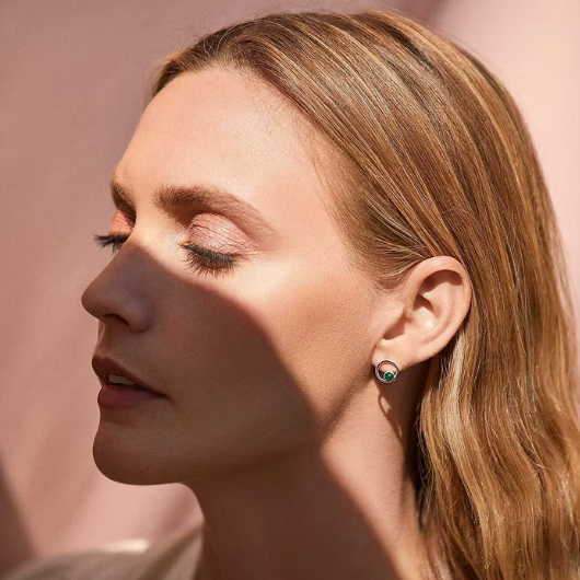 Model wearing Joma Jewellery May Birthstone green agate stud earrings, symbolising balance and prosperity.